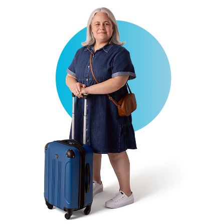 Aly, a person living with XLH, standing with a suitcase and smiling